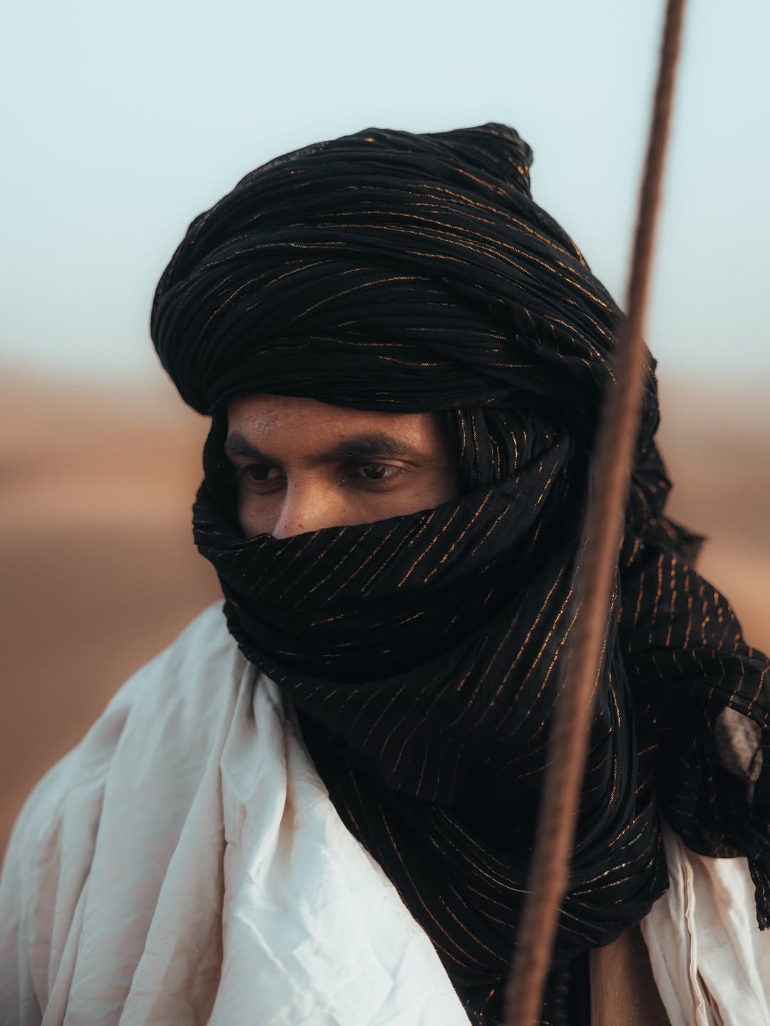 Mohamed, camel guide, wearing a dark desert turban in the Sahara.